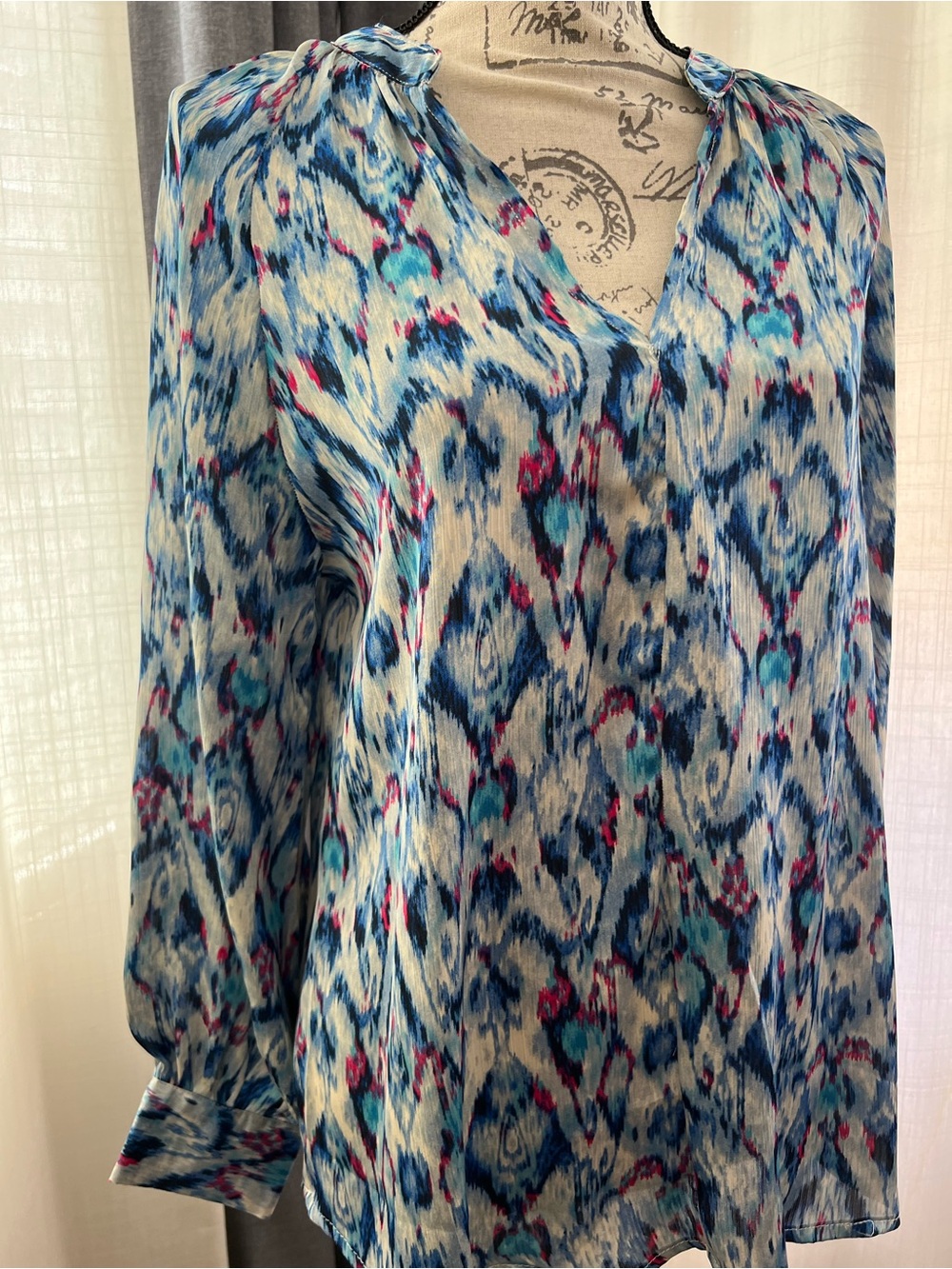 Flowy long sleeve v-neck blouse with water color print.